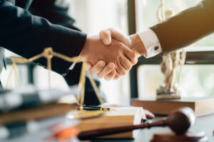 Lawyer shaking hands with male client